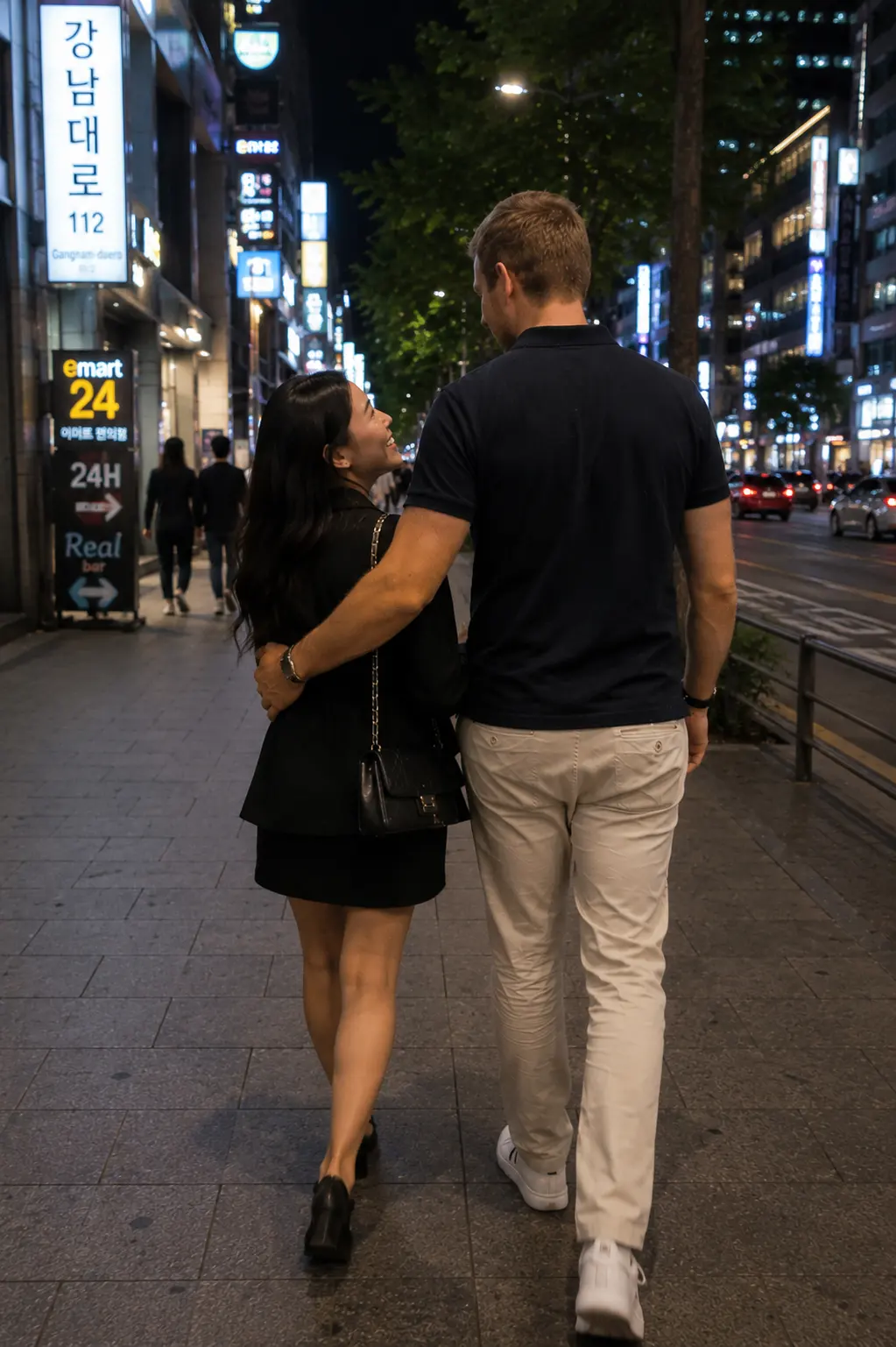 A couple walking through a neon-lit Seoul street at night, seen from behind.