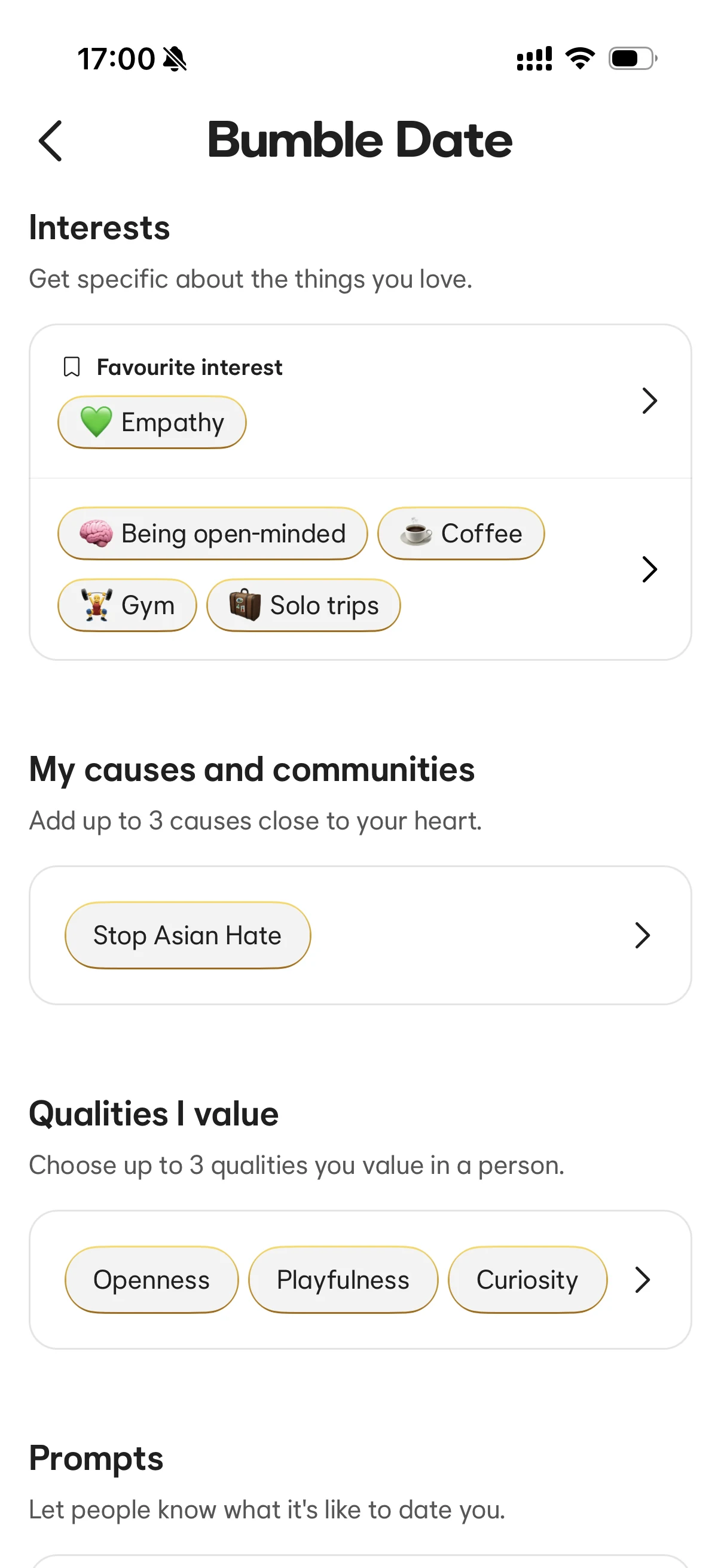 Bumble Date interests and values screen showing empathy, being open-minded, coffee, gym, solo trips, Stop Asian Hate, openness, playfulness, and curiosity